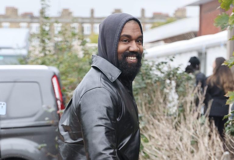 Kanye West becomes the talk of social media as he wear socks and flip-flops during London Fashion Week at the Burberry show.