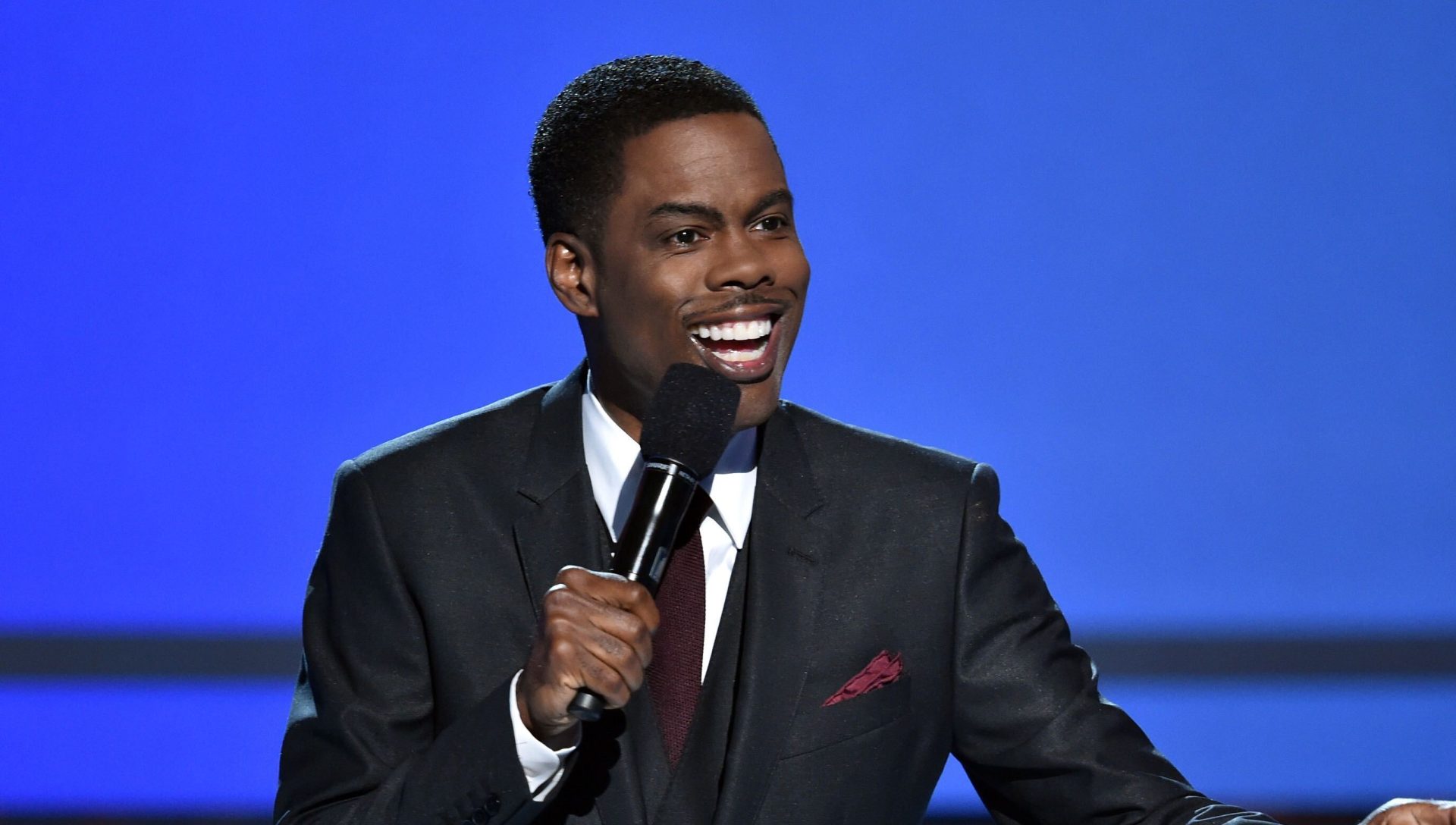 Chris Rock Mocks Will & Jada’s ‘Entanglement,’ Labels Meghan Markle’s Response To Alleged Royal Family Racism As ‘Acting Dumb’ In Netflix Special