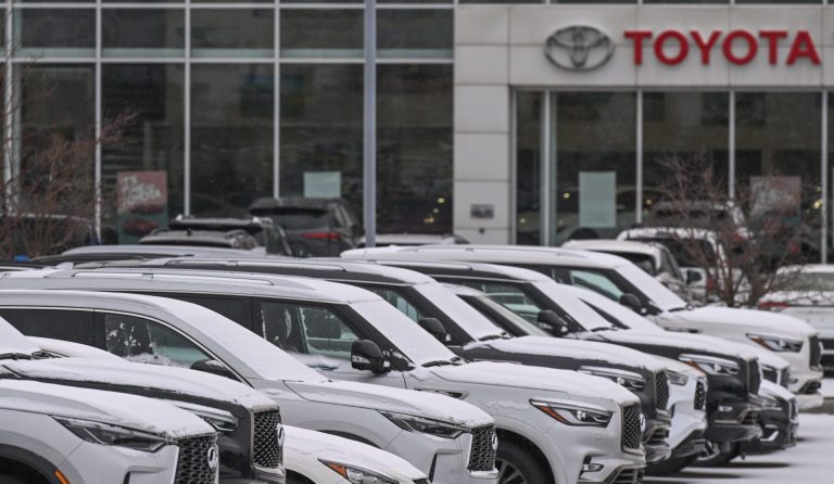 EDMONTON, CANADA - OCTOBER 26, 2023: Toyota logo and vehicles outside a Toyota dealership in Edmonton, on October 26, 2023, in Edmonton, Alberta, Canada.