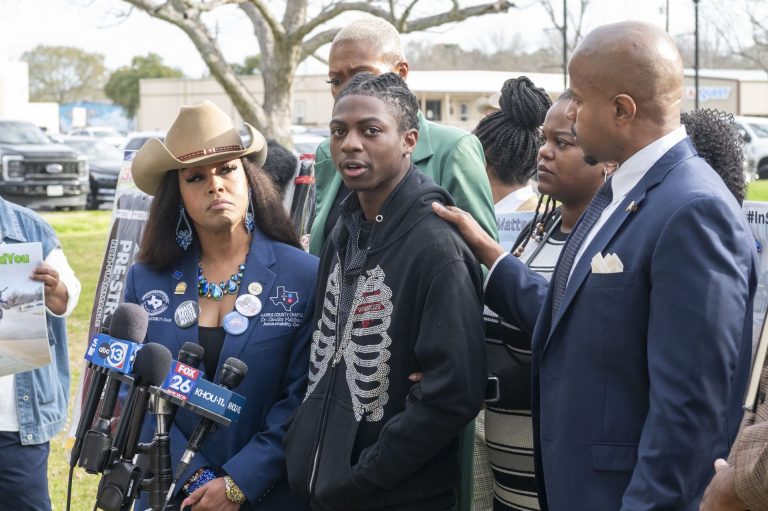 ANAHUAC, TEXAS - FEBRUARY 22: Dr. Candice Matthews, left, listens as state representative Ron Reynolds, right, with Darryl George, center, makes comments before a hearing regarding Georges punishment for violating school dress code policy because of his hair style, Feb. 22, 2024 at the Chambers County Courthouse.