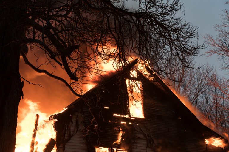 Flames shooting out of a house afire