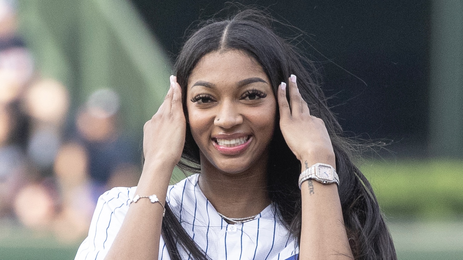 CHICAGO, ILLINOIS - MAY 21: Angel Reese of the Chicago Sky throws out a ceremonial first pitch before a game between the Atlanta Braves and Chicago Cubs at Wrigley Field on May 21, 2024 in Chicago, Illinois.